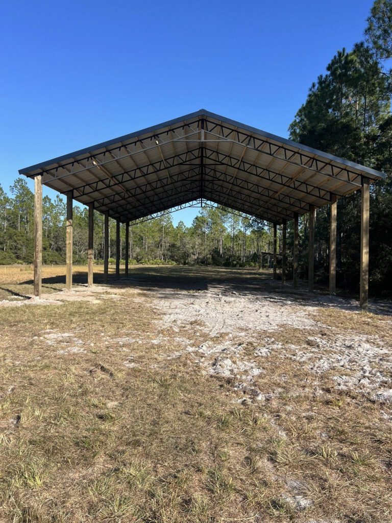 Front view pole barn in pines