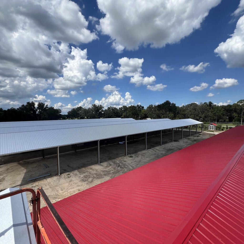 Aerial view of red metal roof on completed pole barn