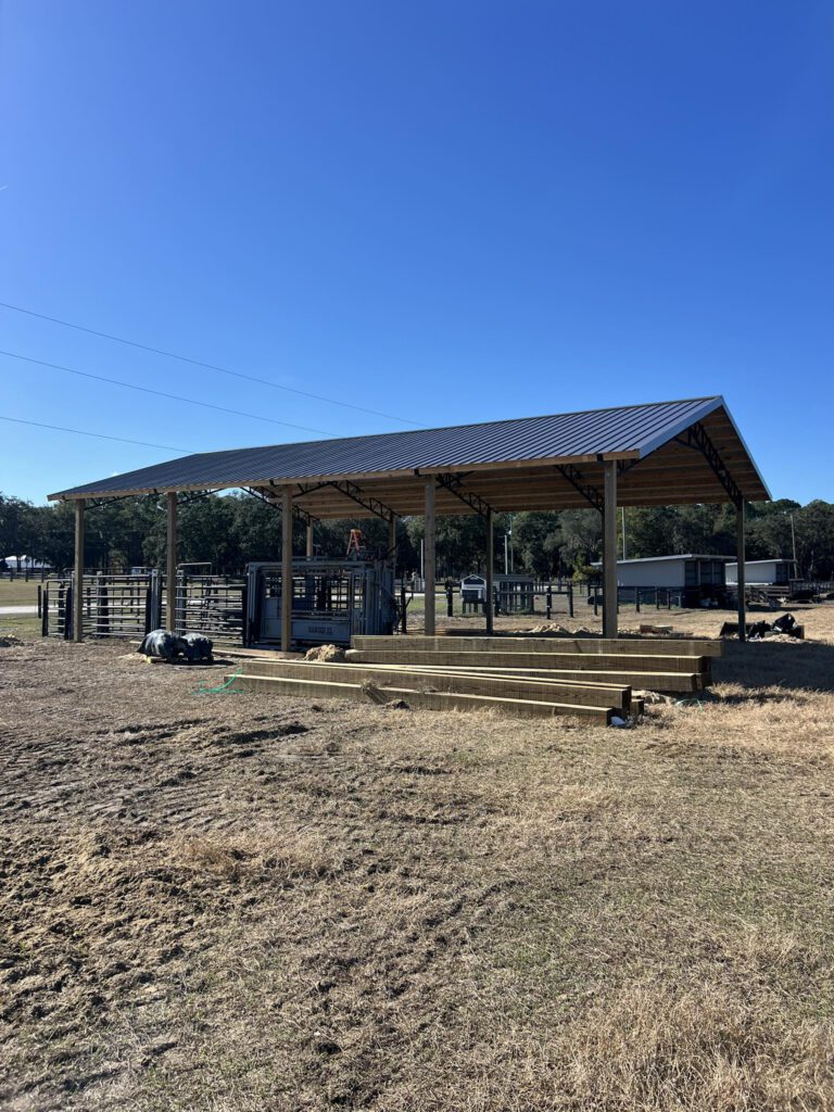 Completed open pole barn with steel trusses and metal roof