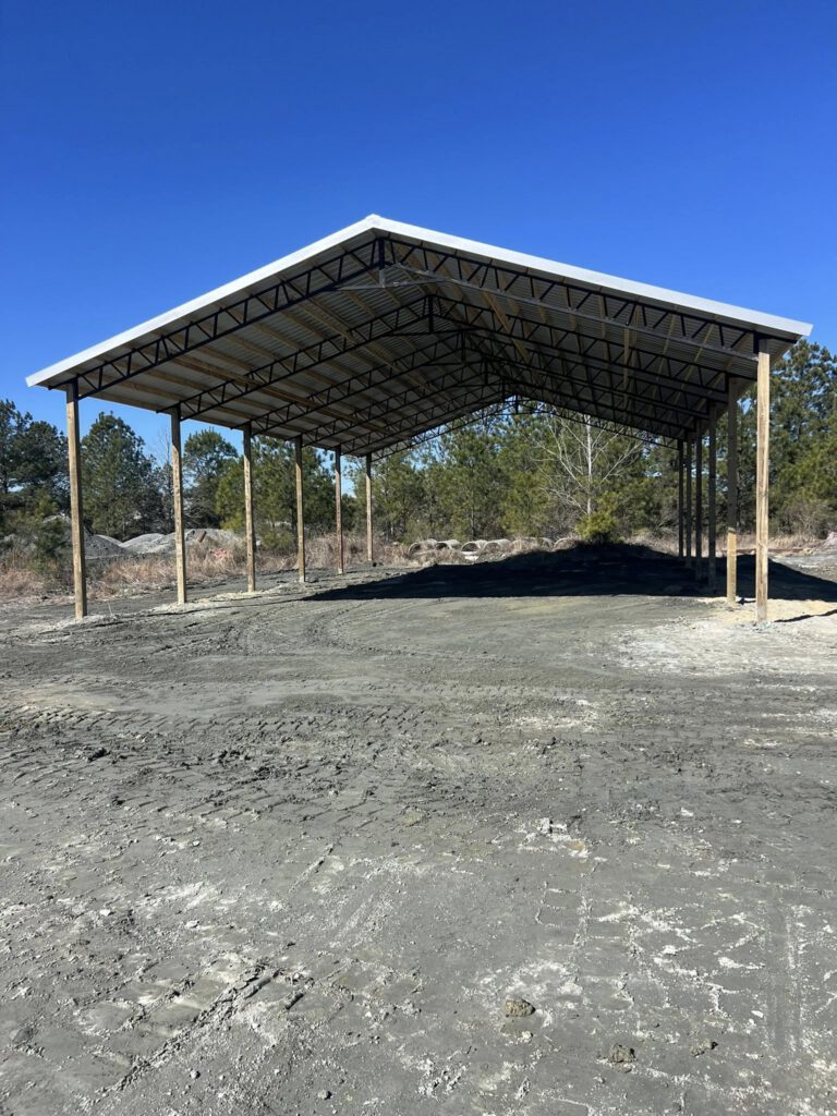 Open-sided steel truss pole barn
